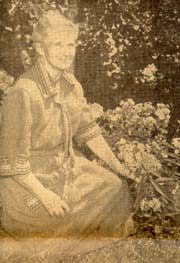 Miss Marguerite Davis, co-discoverer of Vitamin A and Vitamin B, in the garden of the home where three generations of her family have lived. Miss Davis has restored the home as closely as possible to its original state.