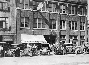 Mitchell models made in Racine by 1913 are shown in in this display in front of Brietzke-Pauli's garage on College Ave. It was Racine's first garage and the first gasoline pump is visible over third auto from right.