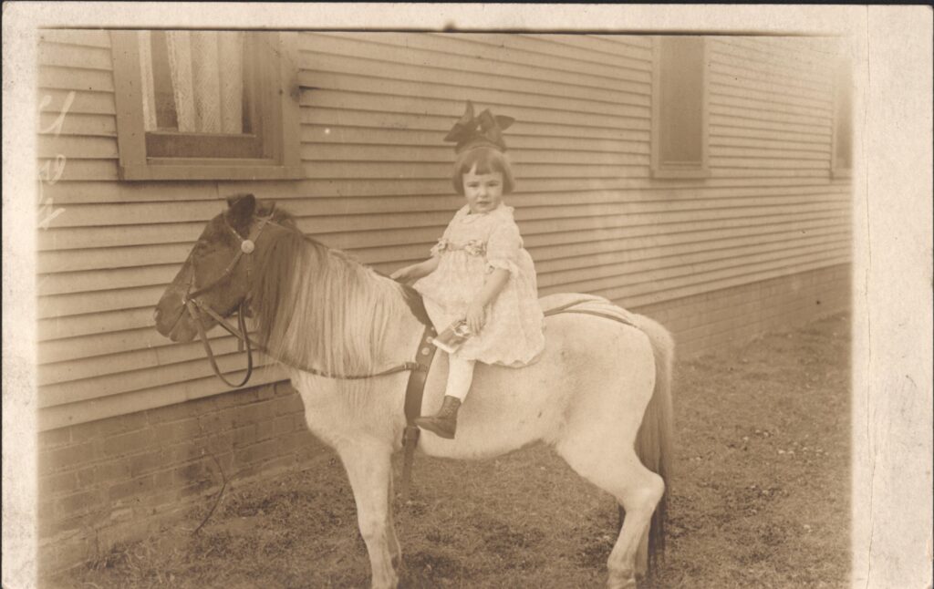 Katherine Pier, age 3 years, on a classic roving photographer's pony. This would have been around 1910 or so.
